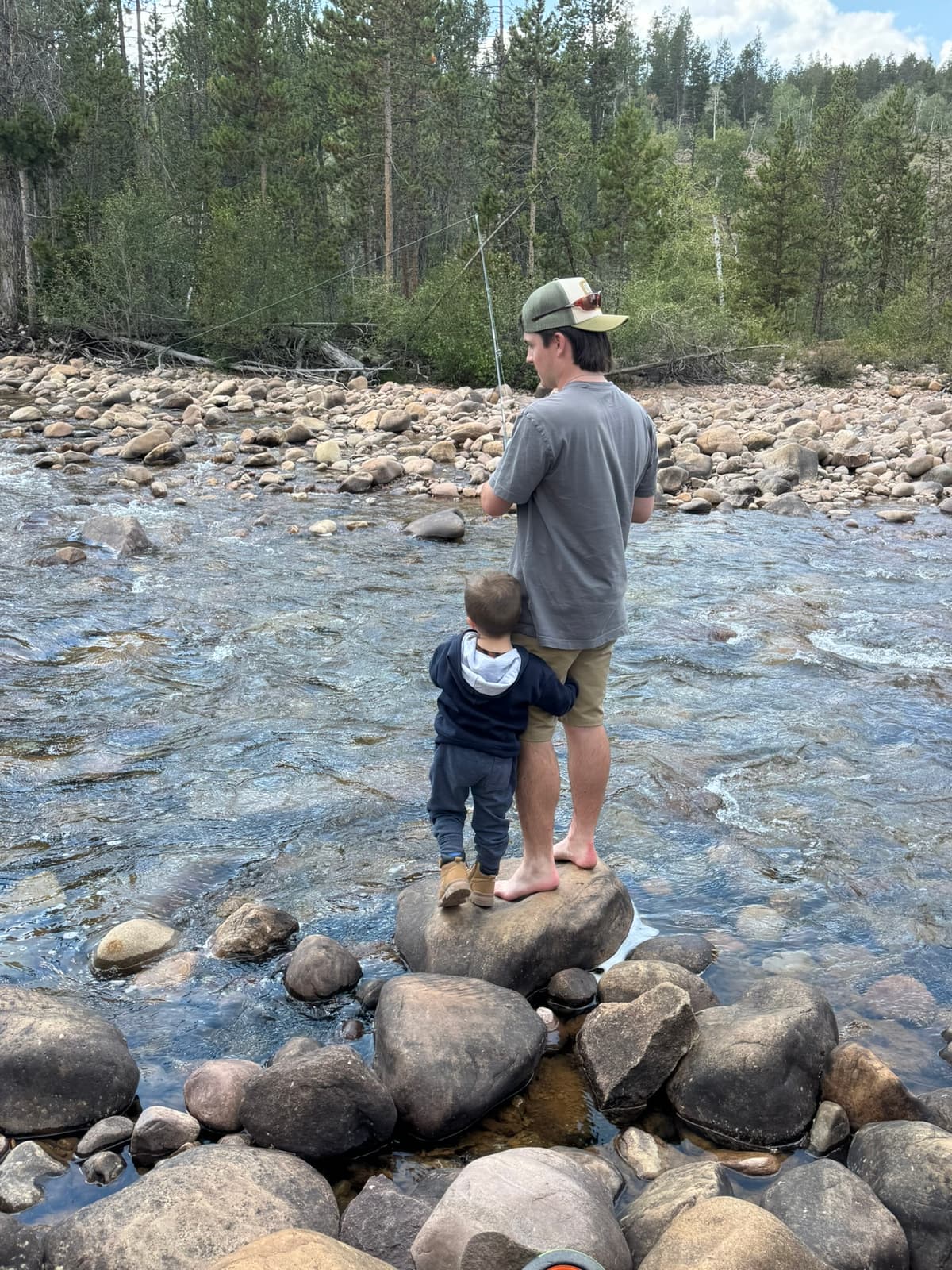 Teaching a toddler to fish on the river