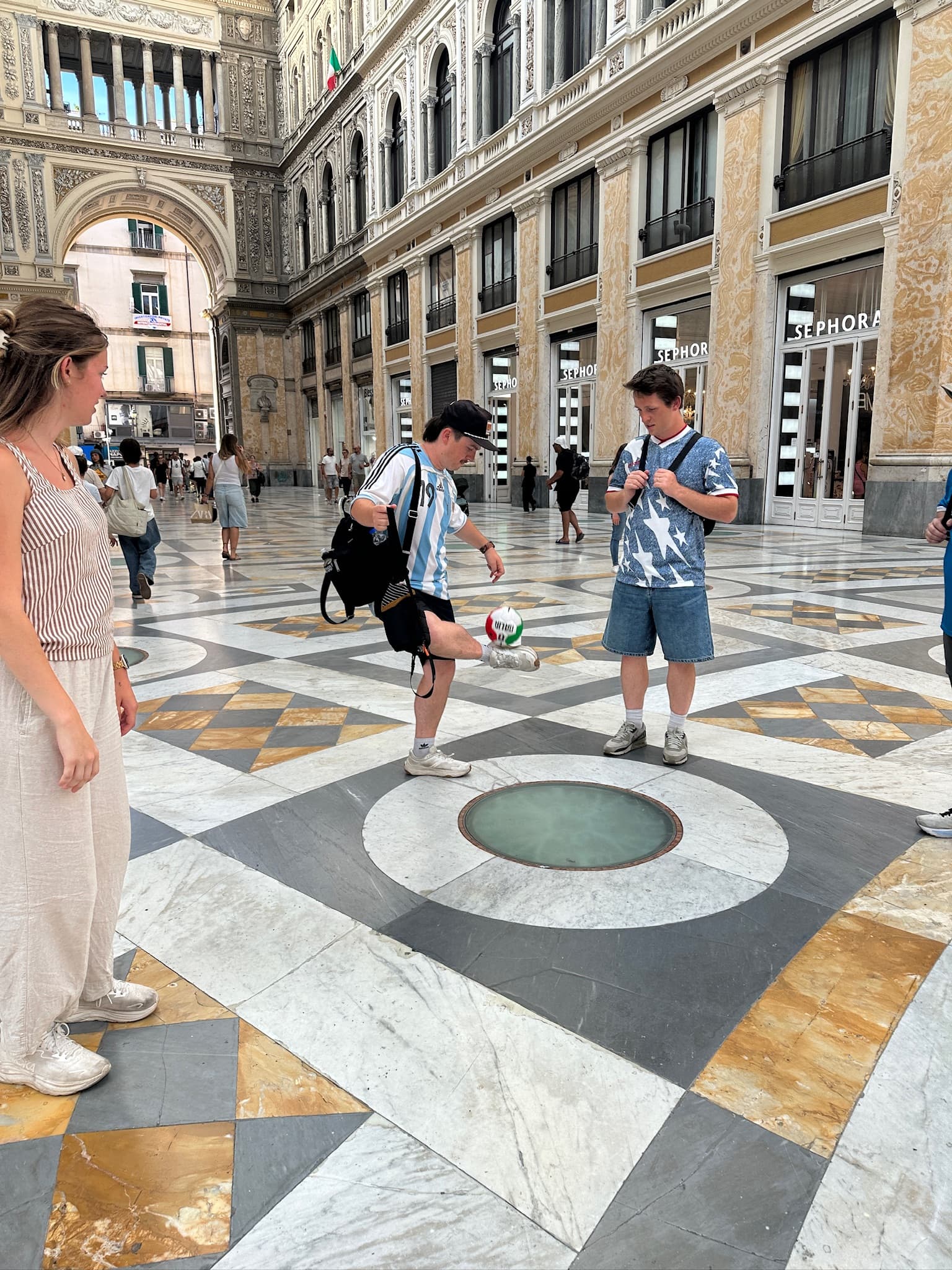 Juggling a soccer ball in the Naples gallery