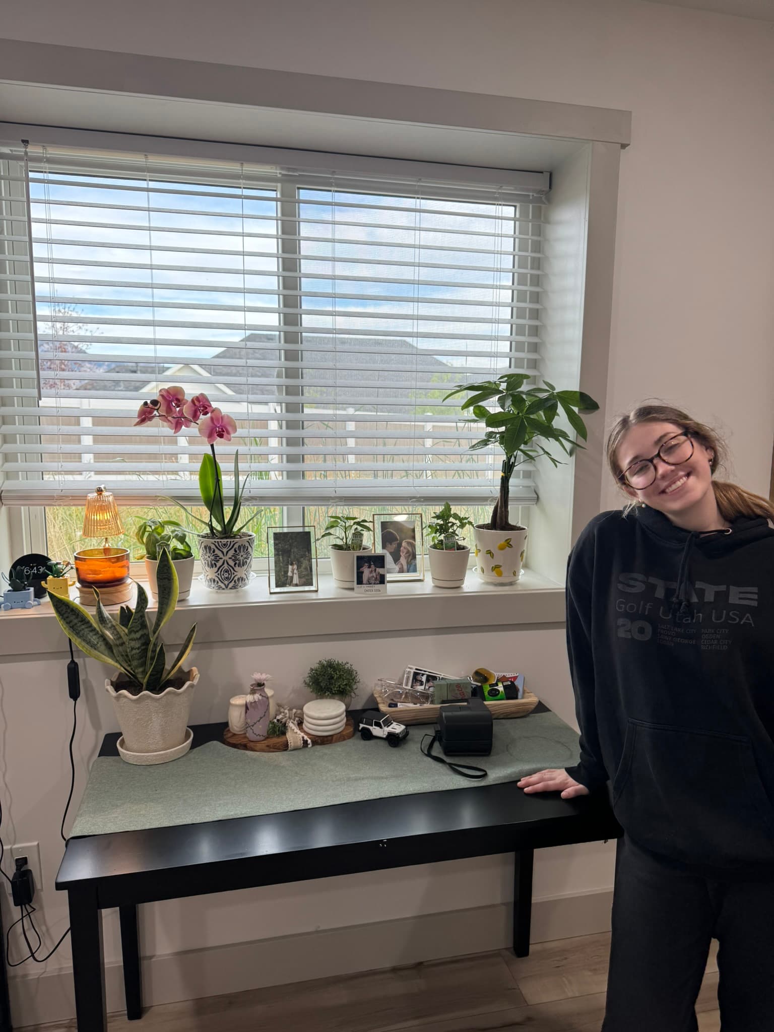 Wife with her plant display at home