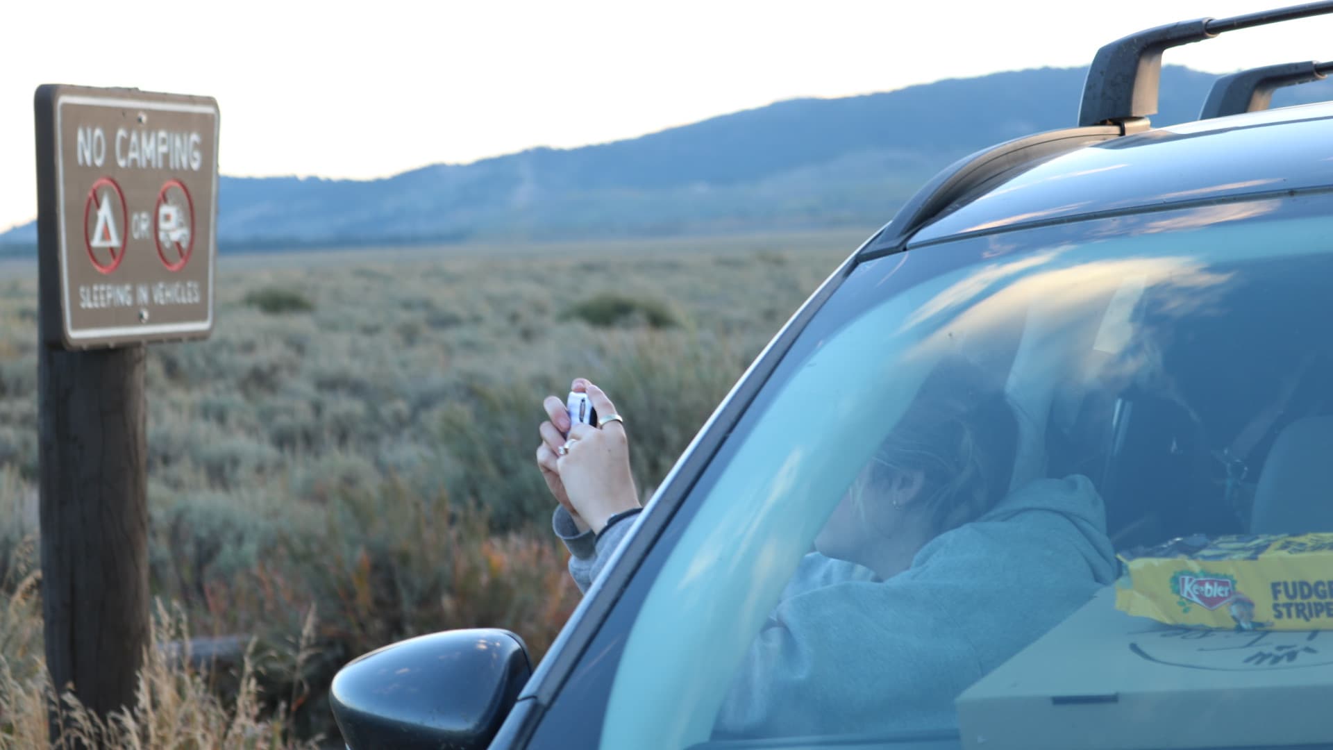Snapping a photo of the No Camping sign at sunrise